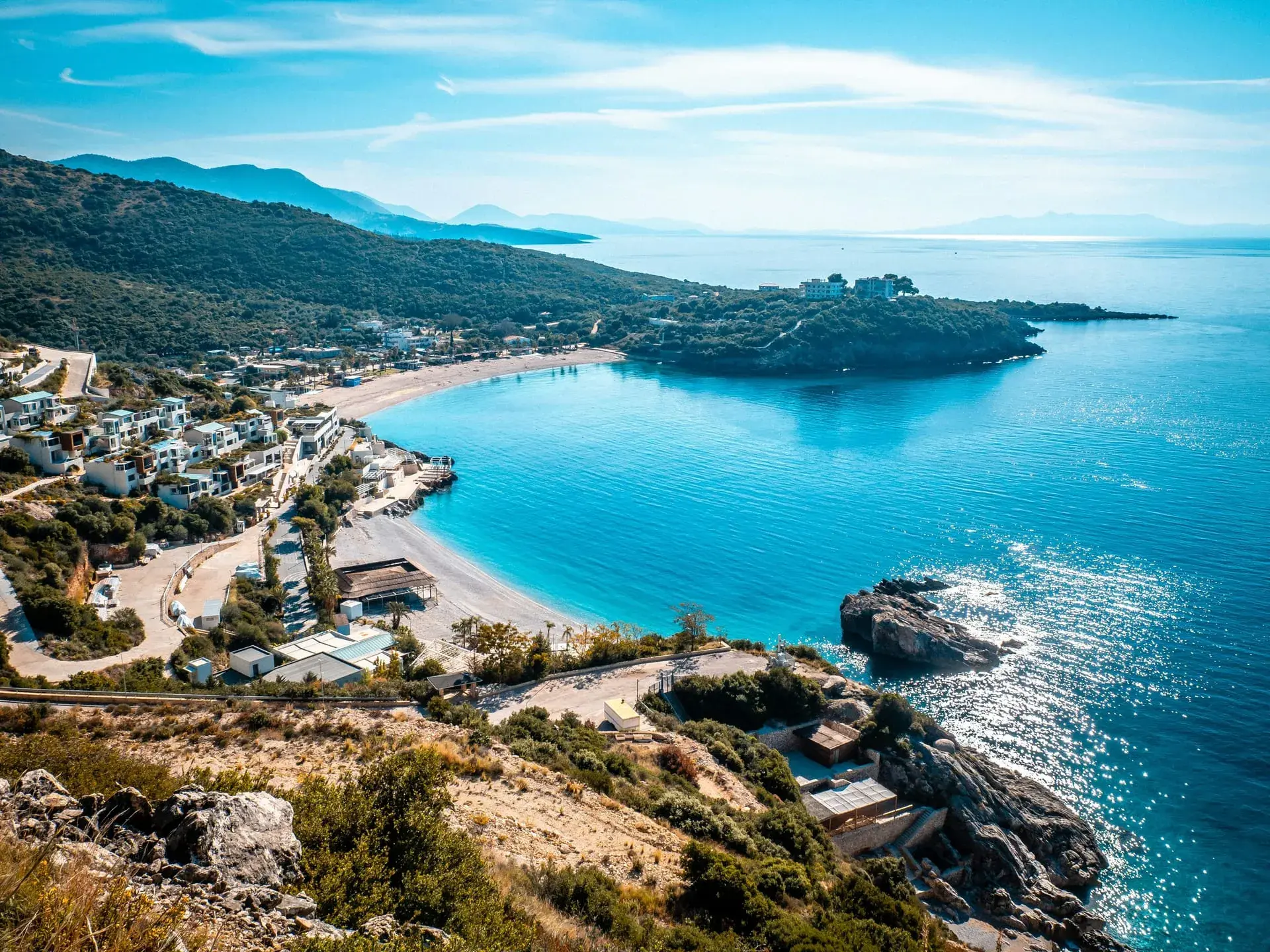 Aerial view of a turquoise bay and beach on the Albanian Riviera